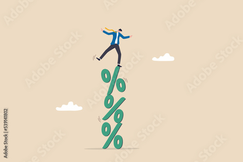 Risky interest rate hike causing business slow down or investment crisis, risk of economic recession, unstable financial or banking debt problem concept, businessman balance on percentage stack. photo