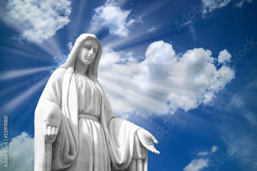 Mary statue on white clouds with light ray at heaven. religion,.