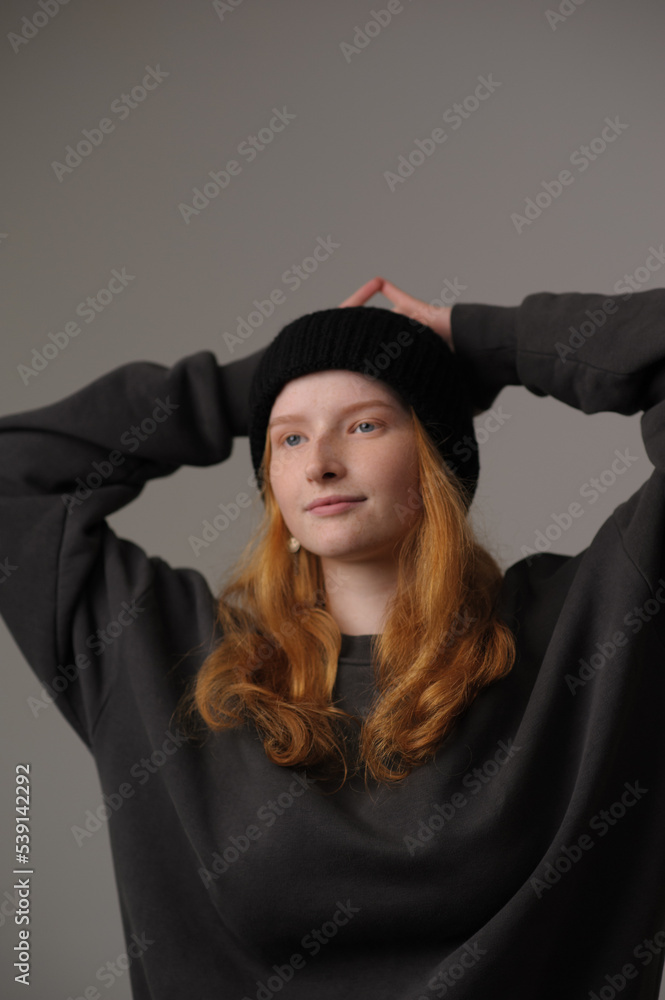 young girl model in black cap and coat isolated on grey background. Product photo mockup for fashion brands and marketplaces. young girl model in black cap and coat isolated on grey background. Product photo mockup for fashion brands and marketplaces.