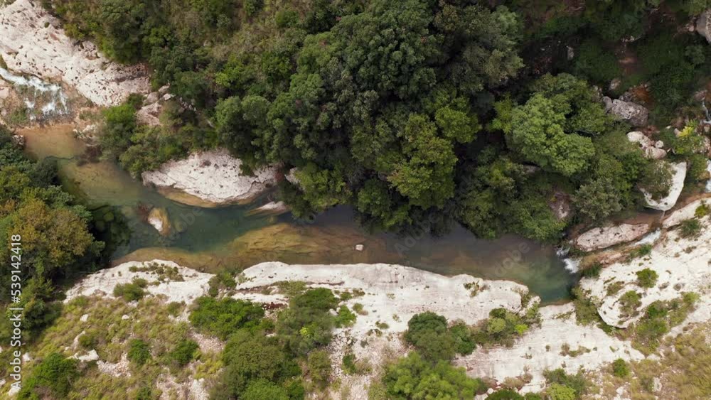 Drone Ascending At The River Stream In Riserva Naturale Orientata Cavagrande Del Cassibile In Syracuse, Italy. Aerial Shot Drone Ascending At The River Stream In Riserva Naturale Orientata Cavagrande Del Cassibile In Syracuse, Italy. Aerial Shot