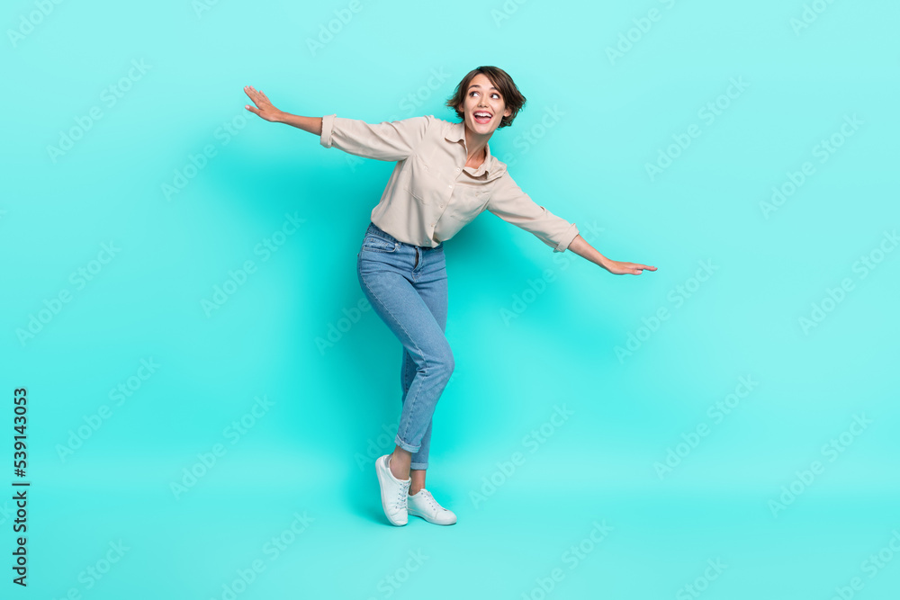 Full length photo of pretty lady stylish outfit open arm look up empty space proposition weekend abroad isolated on cyan color background