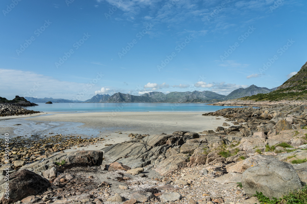 rocky beach with mountains in the background