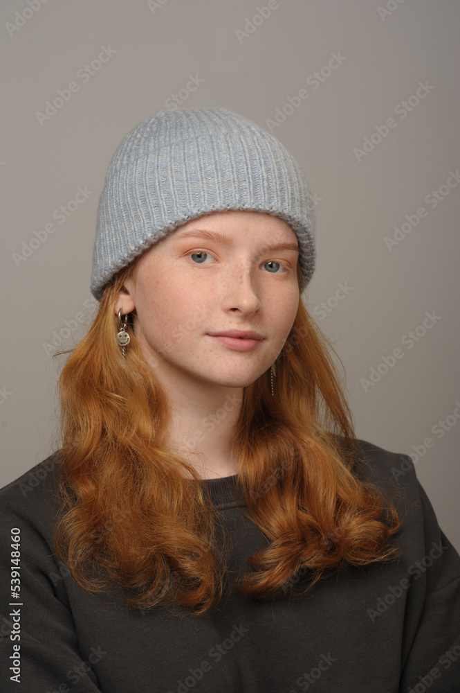 young girl model in light blue cap and gray coat isolated on grey background. Product photo mockup for fashion brands and marketplaces. young girl model in light blue cap and gray coat isolated on grey background. Product photo mockup for fashion brands and marketplaces.