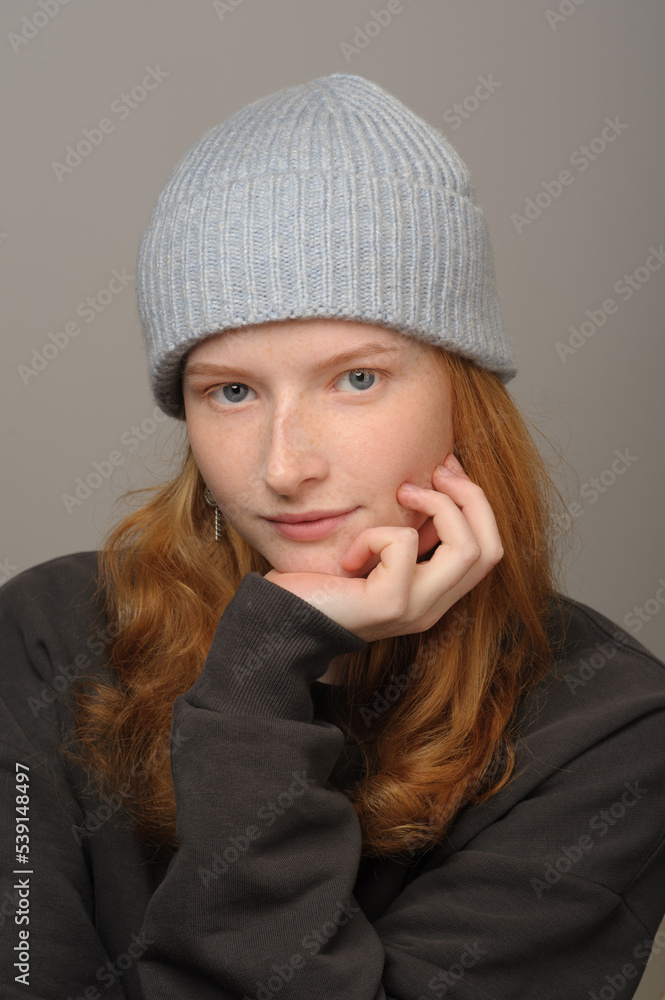 young girl model in light blue cap and gray coat isolated on grey background. Product photo mockup for fashion brands and marketplaces. young girl model in light blue cap and gray coat isolated on grey background. Product photo mockup for fashion brands and marketplaces.