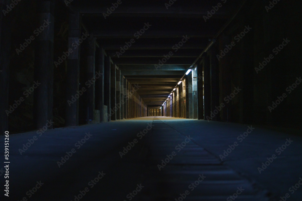 light at the end of tunnel dark underground mining tunnel