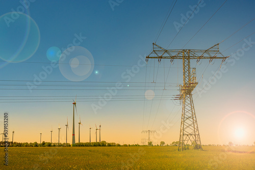 Quadro em tela Beautiful farm landscape and industrial high voltage power line pylons and wind