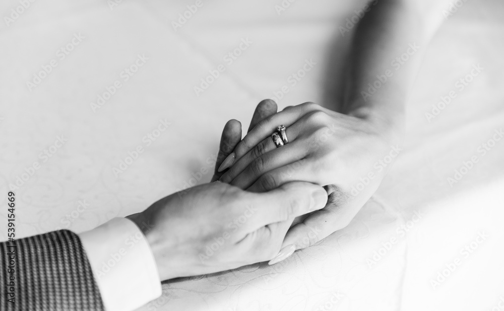 man and woman with wedding ring.Young married couple holding hands,