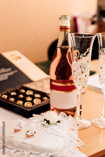 Wedding rings, champagne, sweets on the table. Wedding Day