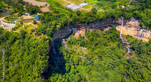 Aerial view photo from flying drone of Two steep waterfalls on the rock cliff at canyon Nam Nao in Phetchabun Province unseen Thailand.Conserve Mineral resources of world Concept. © noon@photo