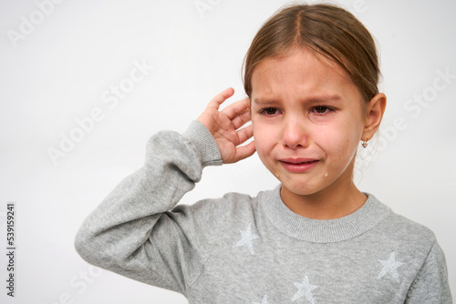 Valokuva Cute little crying girl on white background with copy space