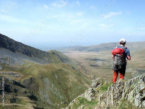 Fototapeta Naklejka Na Ścianę i Meble -  Scotland, Snowdonia. Hiking and climbing ridges through the wilderness during Spring time. Some days are sunny some days are rainy, but all of them are an adventure
