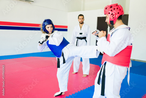 Woman with protective equipment at a taekwondo competition