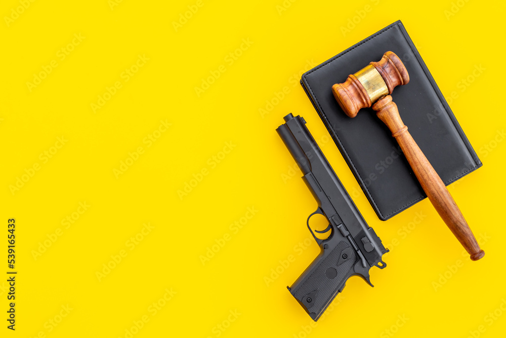 Gun law concept. Hand gun weapon and judges gavel. Crime background Gun law concept. Hand gun weapon and judges gavel. Crime background