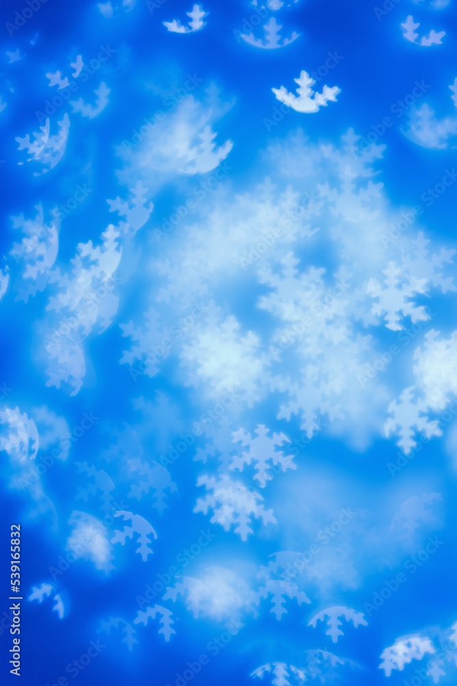 Christmas or New Year abstract magic lights background, white snowflakes bokeh on blue as winter holiday backdrop. Xmas mood aesthetic photo, blurred effect, celebration illumination Christmas or New Year abstract magic lights background, white snowflakes bokeh on blue as winter holiday backdrop. Xmas mood aesthetic photo, blurred effect, celebration illumination