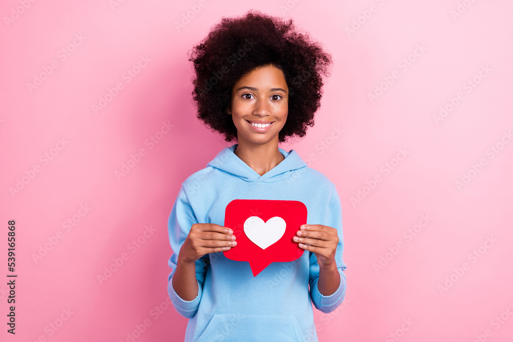 Photo portrait of adorable school girl holding heart notification symbol wear trendy blue garment isolated on pink color background Photo portrait of adorable school girl holding heart notification symbol wear trendy blue garment isolated on pink color background
