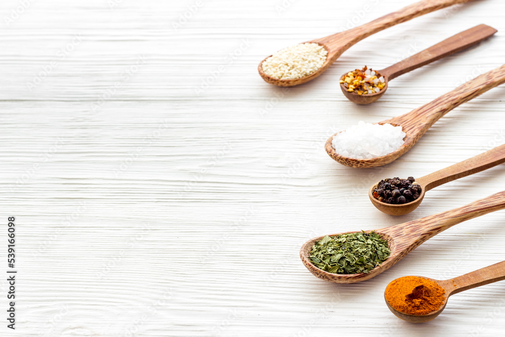 Powdered spices and herbs in wooden spoons. Colorful cooking background Powdered spices and herbs in wooden spoons. Colorful cooking background