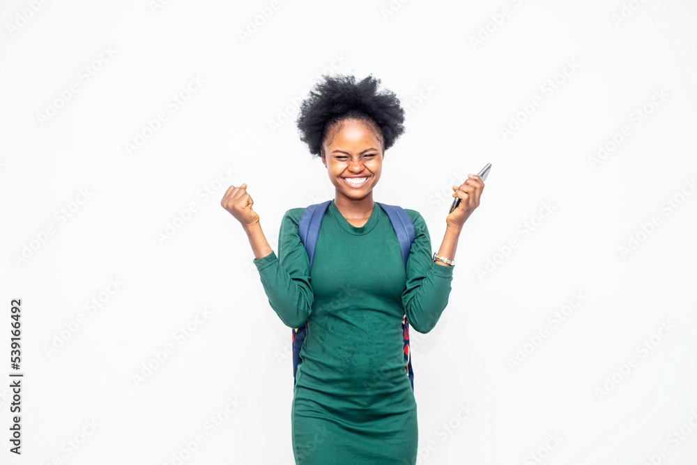 Happy African portrait beautiful cute young woman standing winning and surprised excited screaming open mouth raise hands, studio shot isolated white background, wow expression Happy African portrait beautiful cute young woman standing winning and surprised excited screaming open mouth raise hands, studio shot isolated white background, wow expression