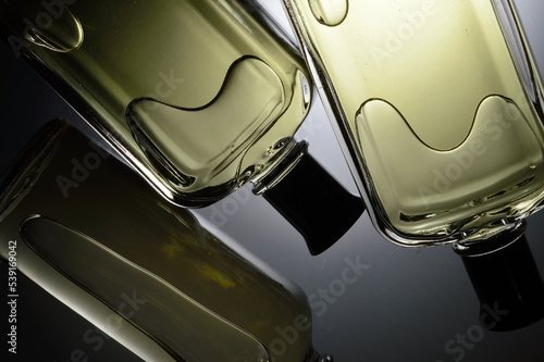 transparent jars with perfume lie on a light background. Close-up