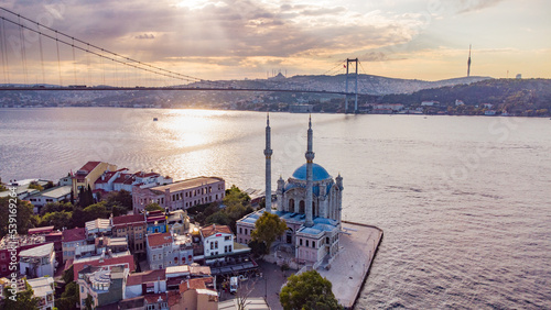 Skyscrapers of istanbul behind Ortaköy Camii mosque and city behind, aerial view of the Bosporous in Istanbul photo