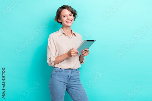 Photo of young charming adorable pretty businesswoman hold tablet gadget assistant ready help you isolated on aquamarine color background