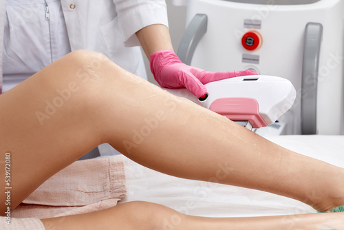 Laser depilation or photoepilator process on a woman leg.