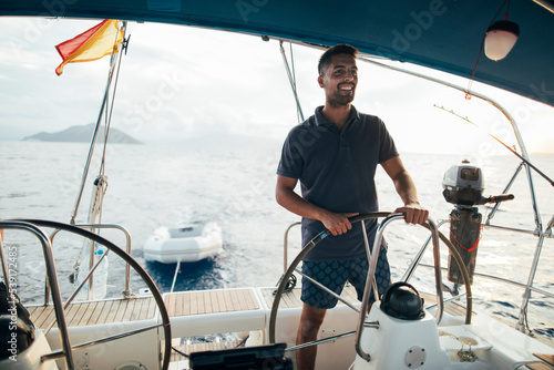 Smiling young man enjoy sailing on  © yossarian6