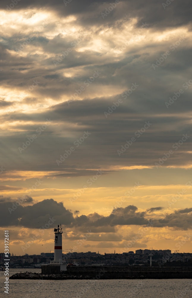 Marvelous yellow mystical dramatic sky over Istanbul over a lighthouse in Kadiköy