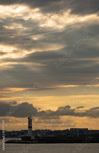 Marvelous yellow mystical dramatic sky over Istanbul over a lighthouse in Kadik  y