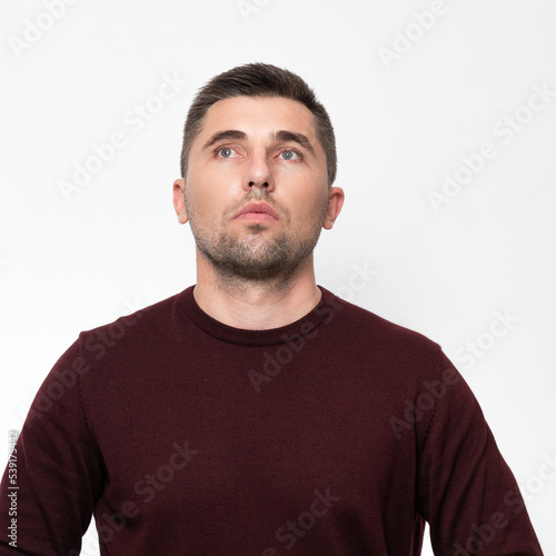 Portrait of an adult man on a white background in a sweater.