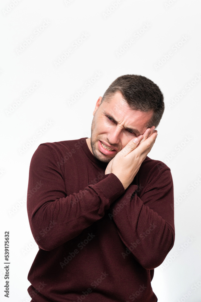 A man suffers from a toothache, portrait on a white background. A man suffers from a toothache, portrait on a white background.