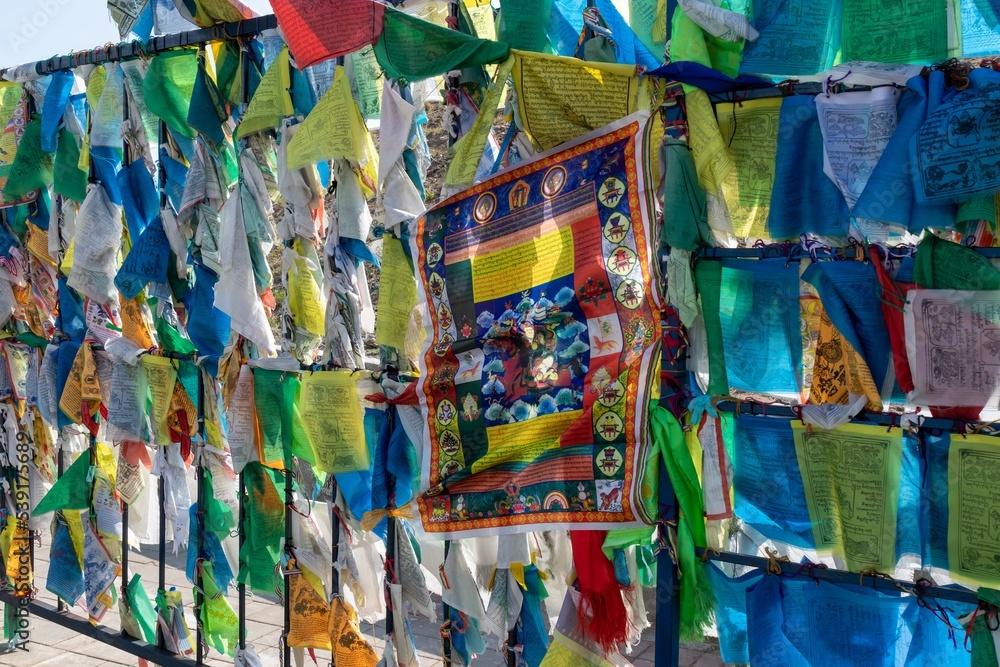 Multicolored Buddhist prayer flags with sacred animals and Buddha