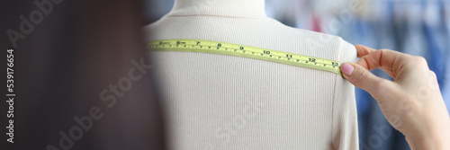 Billede på lærred A woman measures the width with a tape on a mannequin