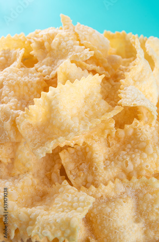 Sfrappole or chiachiere or angel wings background. Italian Carnival and TYPICAL food. Traditional sweet crisp pastry deep-fried and sprinkled . Copy space, Banner 
