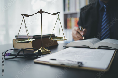 Lawyer businessmฟn working with contract papers and wooden gavel on table in courtroom. Justice and law, attorney, court judge, concept.