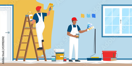 Professional painters and decorators painting a wall