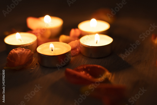 Rose petals and a set of scented candles  a romantic evening.