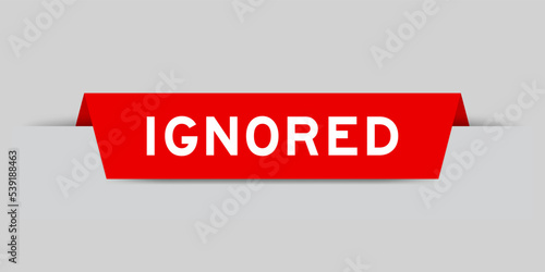 Red color inserted label with word ignored on gray background