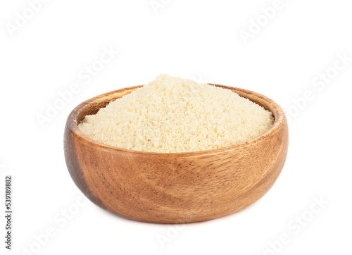 Wooden bowl full of almond flour isolated on white background.