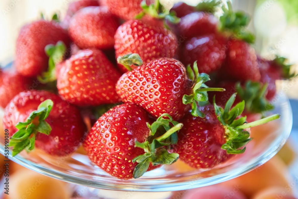 Fruit red ripe strawberries, several berries, close-up. Ecological products grown in the garden, vegetarian diet. Fruit red ripe strawberries, several berries, close-up. Ecological products grown in the garden, vegetarian diet.