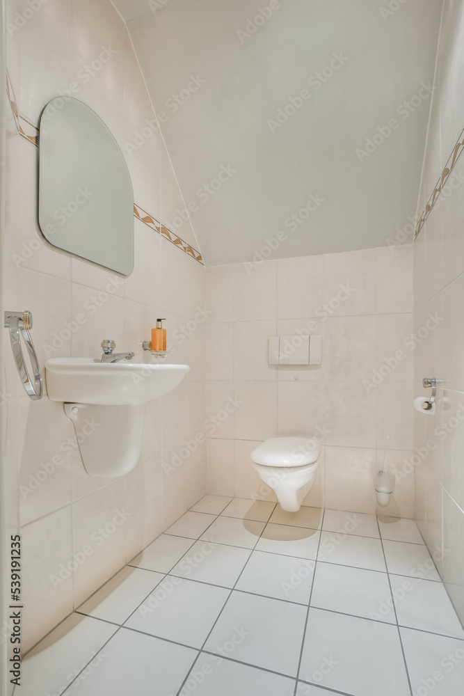 mirror hanging on tiled wall over white ceramic sink in contemporary bathroom mirror hanging on tiled wall over white ceramic sink in contemporary bathroom