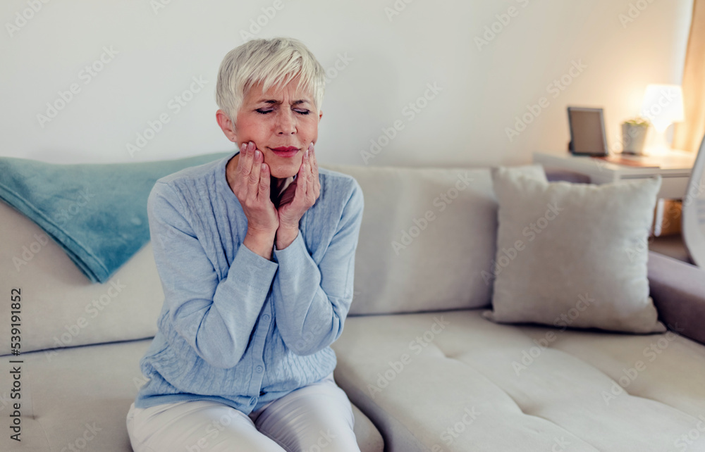 Tooth pain. Woman feeling tooth pain. Closeup of beautiful sad women suffering from strong tooth pain. Attractive mature female feeling painful toothache. Dental health and care concept. Tooth pain. Woman feeling tooth pain. Closeup of beautiful sad women suffering from strong tooth pain. Attractive mature female feeling painful toothache. Dental health and care concept.