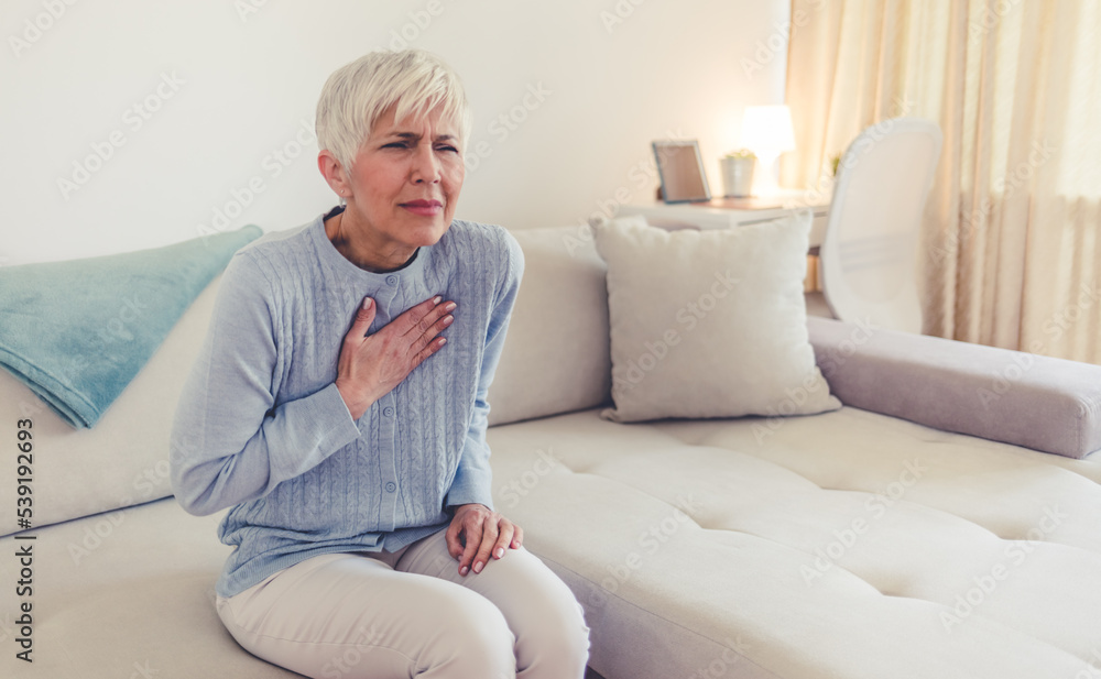 Heart attack concept. Woman suffering from chest pain, Health care. Severe heartache, Having heart attack or Painful cramps, Pressing on chest with painful expression. Heart attack concept. Woman suffering from chest pain, Health care. Severe heartache, Having heart attack or Painful cramps, Pressing on chest with painful expression.