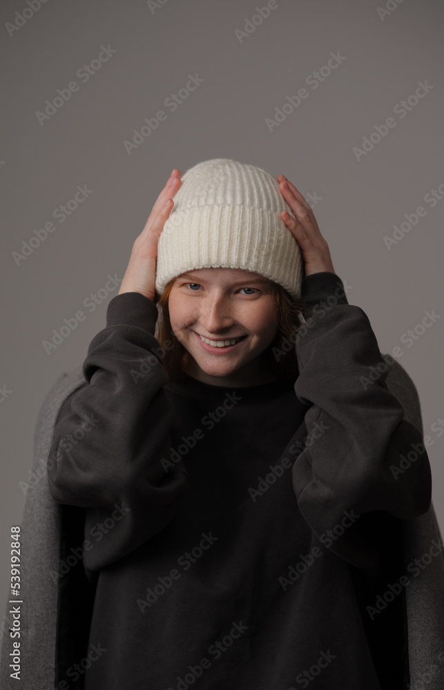 young girl model in white cap and gray coat isolated on grey background. Product photo mockup for fashion brands and marketplaces. young girl model in white cap and gray coat isolated on grey background. Product photo mockup for fashion brands and marketplaces.