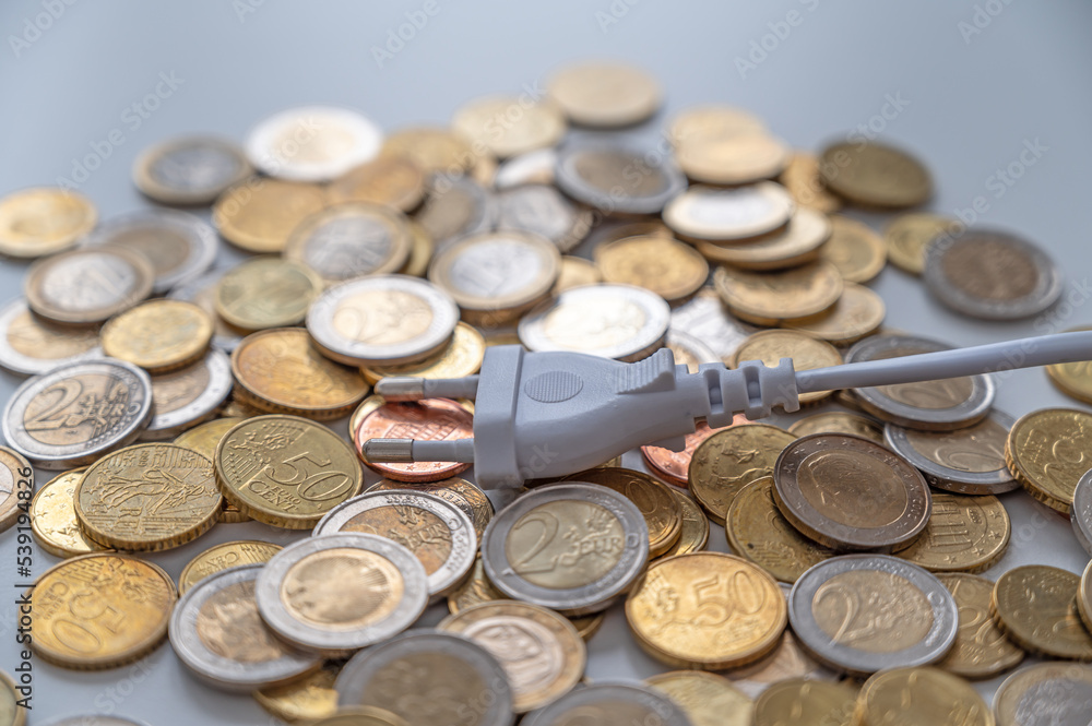 White electric plug, placed on a background of Euro coins. Increase in electricity bills, increases in electricity and energy costs.
White electric plug, placed on a background of Euro coins. Increase in electricity bills, increases in electricity and energy costs.