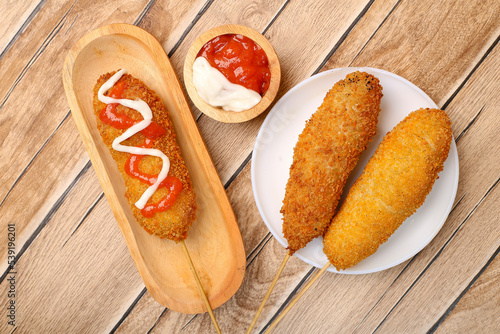 Mozarella Corndog with sauce and mayonaise. hotdog style Korean street food popular, in indonesia called Hotang