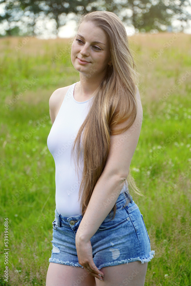 Beautiful young woman enjoys summer in nature Beautiful young woman enjoys summer in nature