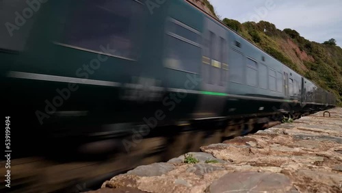 Teignmouth, Dorset UK - September 2022: GWR train travelling towards camera in 4k. Real time motion of train travel