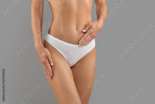 Women's Health Care. Female In White Panties Holding Hand On Belly, Cropped
