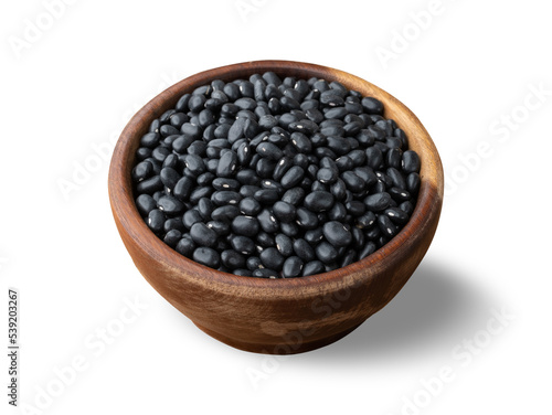 Raw black beans on a wooden bowl isolated over white background