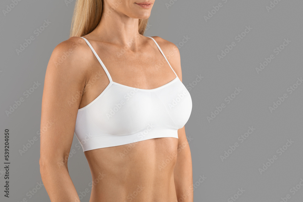 Cropped Shot Of Young Smiling Woman In White Top Bra